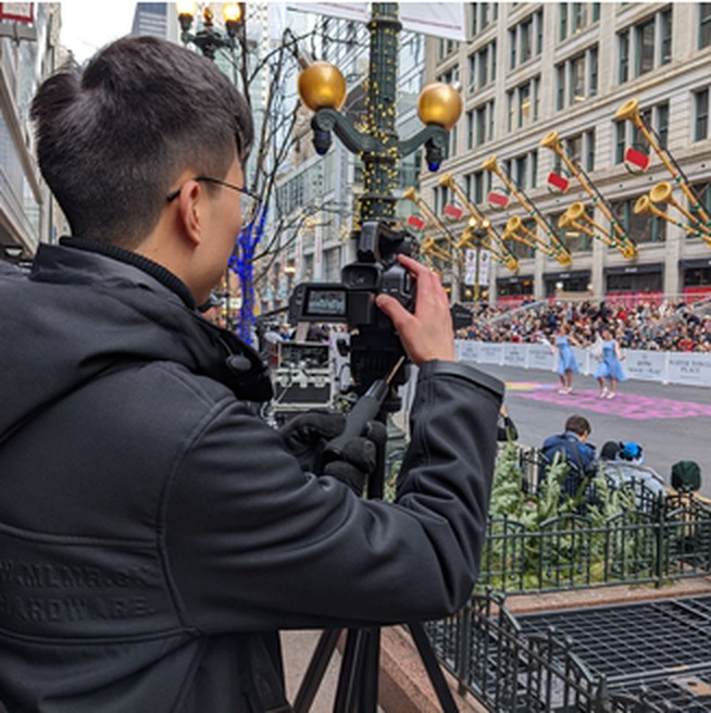 Video camera operator recording a community event